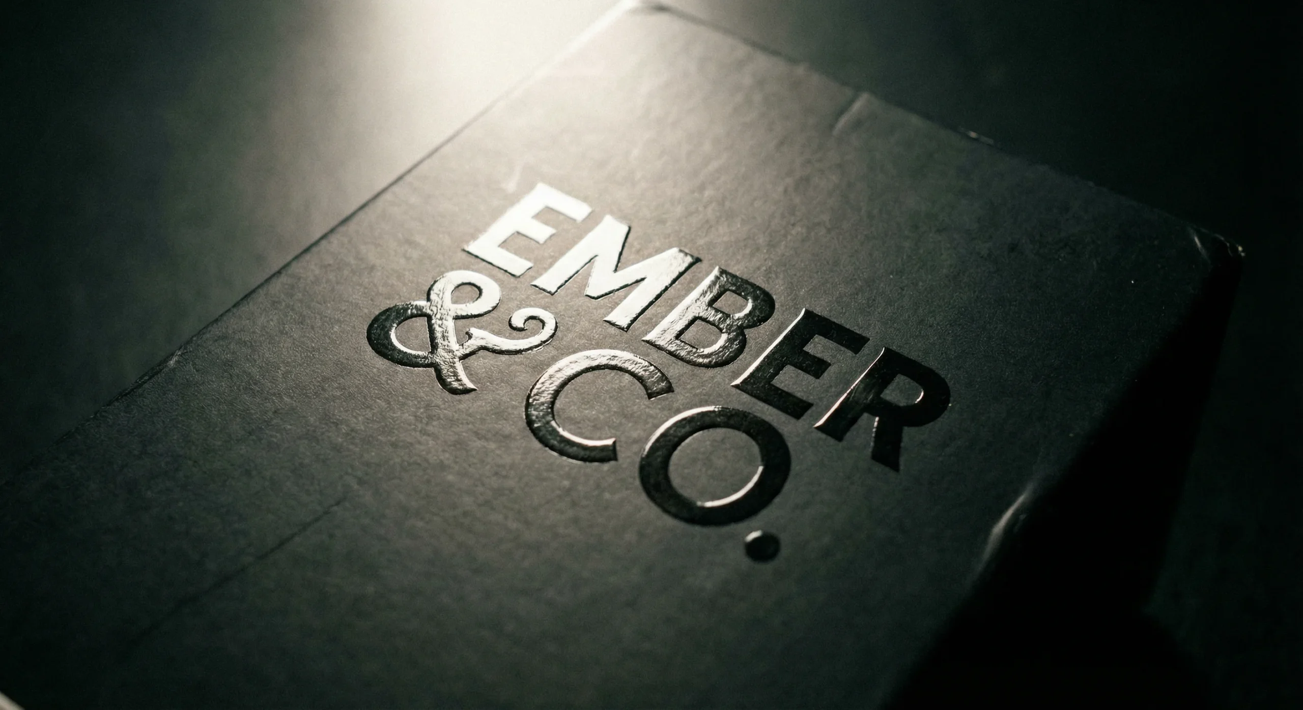 Detailed macro shot of Spot UV on matte finish showing glossy logo on dull background.